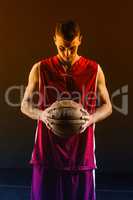Portrait of basketball player holding a ball