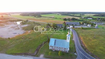 Old catholic church building. Summer nature landscape. Aerial footage.