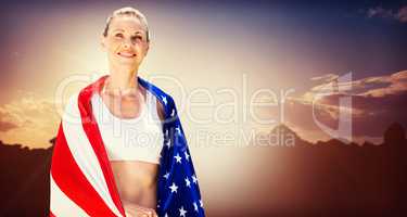Portrait of american sportswoman is smiling  against composite i