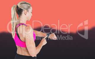 Composite image of female athlete using her smart watch