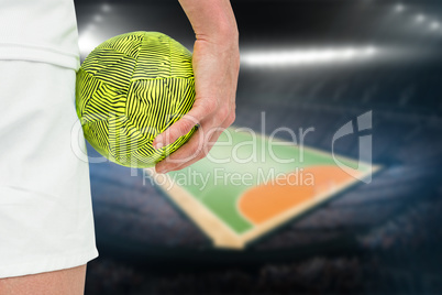 Composite image of sportswoman holding a ball