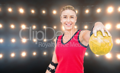 Composite image of female athlete with elbow pad holding handbal