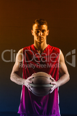 Portrait of basketball player holding a ball