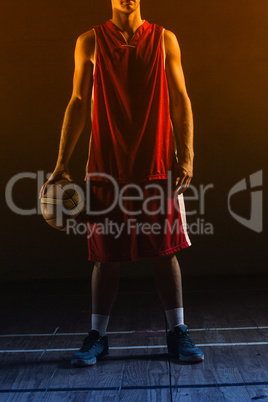 Portrait of basketball player holding a ball