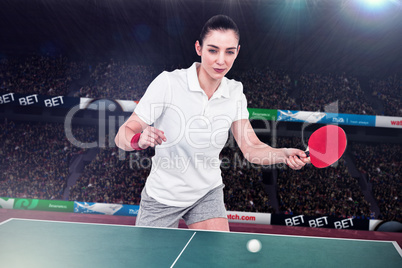 Composite image of female athlete playing ping pong