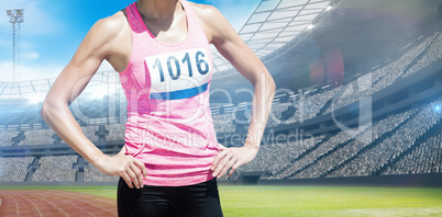 Composite image of sportswoman chest is posing with hands on hip