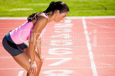 Composite image of profile view of breathless sportswoman