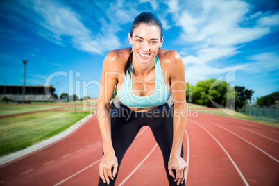 Composite image of sportswoman posing his hands on knee