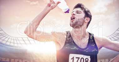 Composite image of portrait of sportsman drinking