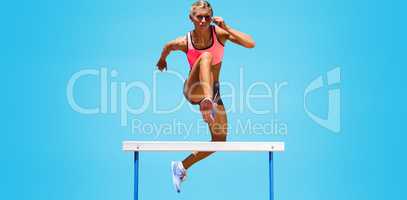 Athletic woman practicing show jumping