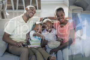 Composite image of family are watching sport on television