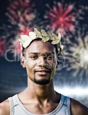 Composite image of portrait of victorious sportsman with crown of laurels