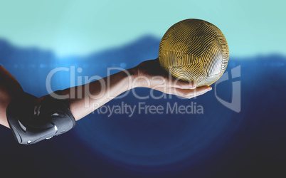 Composite image of female athlete with elbow pad holding handbal