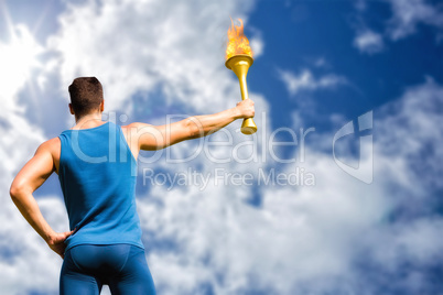 Composite image of rear view of athletic man holding the olympic