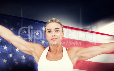 Composite image of female athlete holding american flag