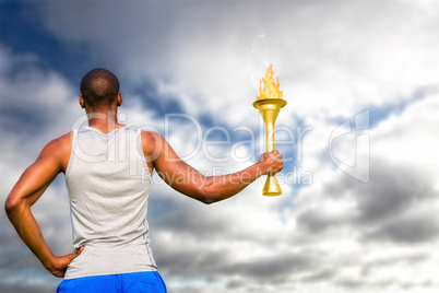 Composite image of rear view of sportsman holding a cup