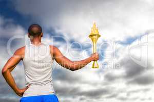 Composite image of rear view of sportsman holding a cup