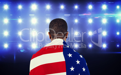 Composite image of athlete with american flag wrapped around his