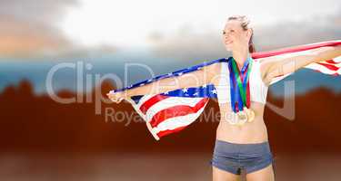Composite image of portrait of happy sportswoman with medals hol