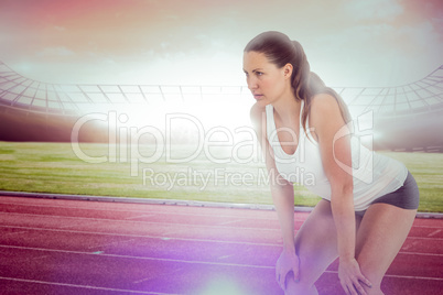Composite image of tired athlete standing with hand on knee
