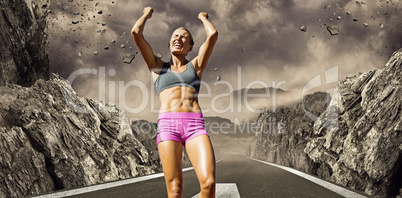 Composite image of low angle view of sportswoman celebrating her