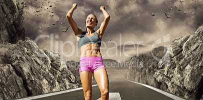 Composite image of low angle view of sportswoman celebrating her