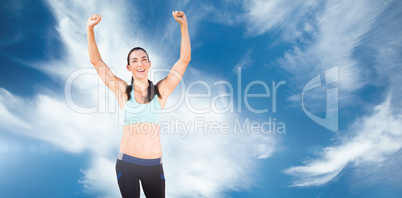 Sporty woman raising her arms