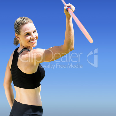 Rear view of sporty woman holding a javelin Rear view of sporty woman holding a javelin