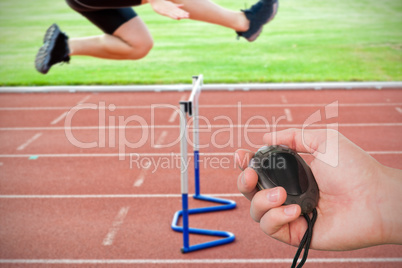 Composite image of coach is holding a stopwatch against assertiv