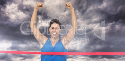 Composite image of portrait of cheerful winner athlete crossing