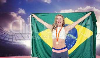 Composite image of athlete posing with gold medal after victory