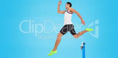 Male athlete running on blue background