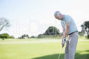 Focused man doing golf