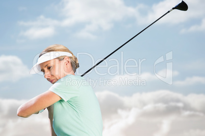Composite image of woman playing golf