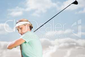 Composite image of woman playing golf