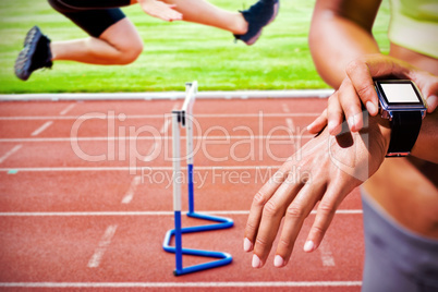 Composite image of close up on a sportswoman wearing a connected