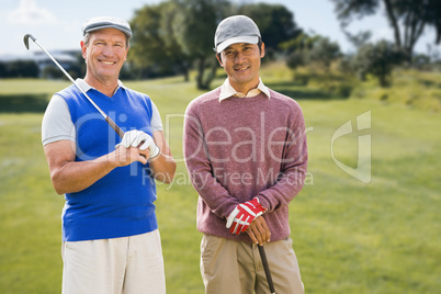 Composite image of men holding golf club