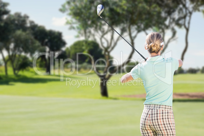 Rear view of woman playing golf
