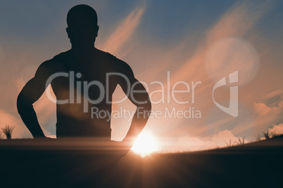 Composite image of athlete standing with hand on hip Composite image of athlete standing with hand on hip