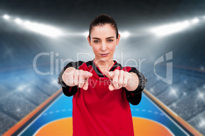 Composite image of female athlete posing with elbow pad and poin