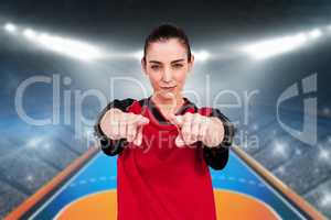 Composite image of female athlete posing with elbow pad and poin