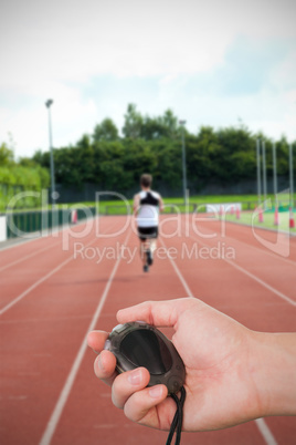 Composite image of close up of coach is holding a stopwatch