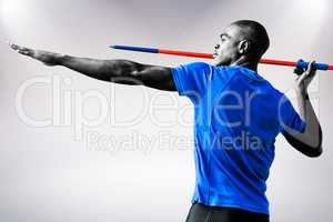 Composite image of profile view of sportsman practising javelin