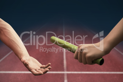 Athlete passing a baton to the partner