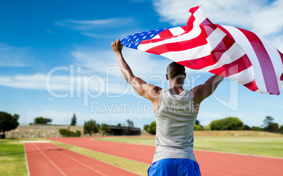 Composite image of rear view of athletic man holding the america