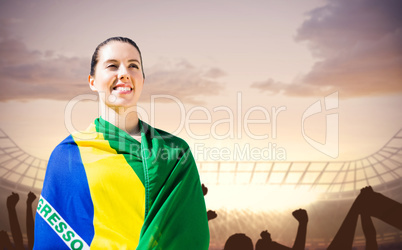 Composite image of sporty woman holding brazilian flag