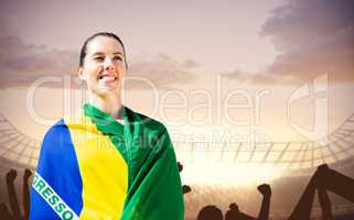 Composite image of sporty woman holding brazilian flag