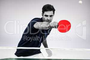 Composite image of portrait of male athlete playing table tennis