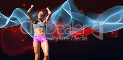 Composite image of low angle view of sportswoman celebrating her