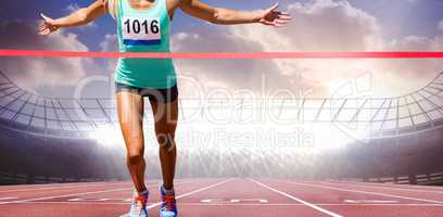 Composite image of sportswoman finishing her run